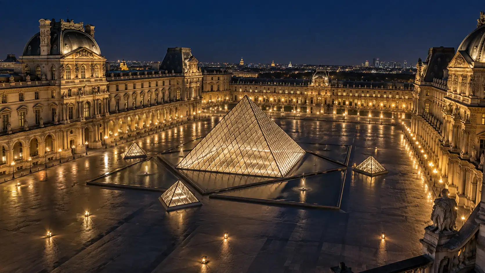 The Louvre courtyard and glass pyramid lit up at night