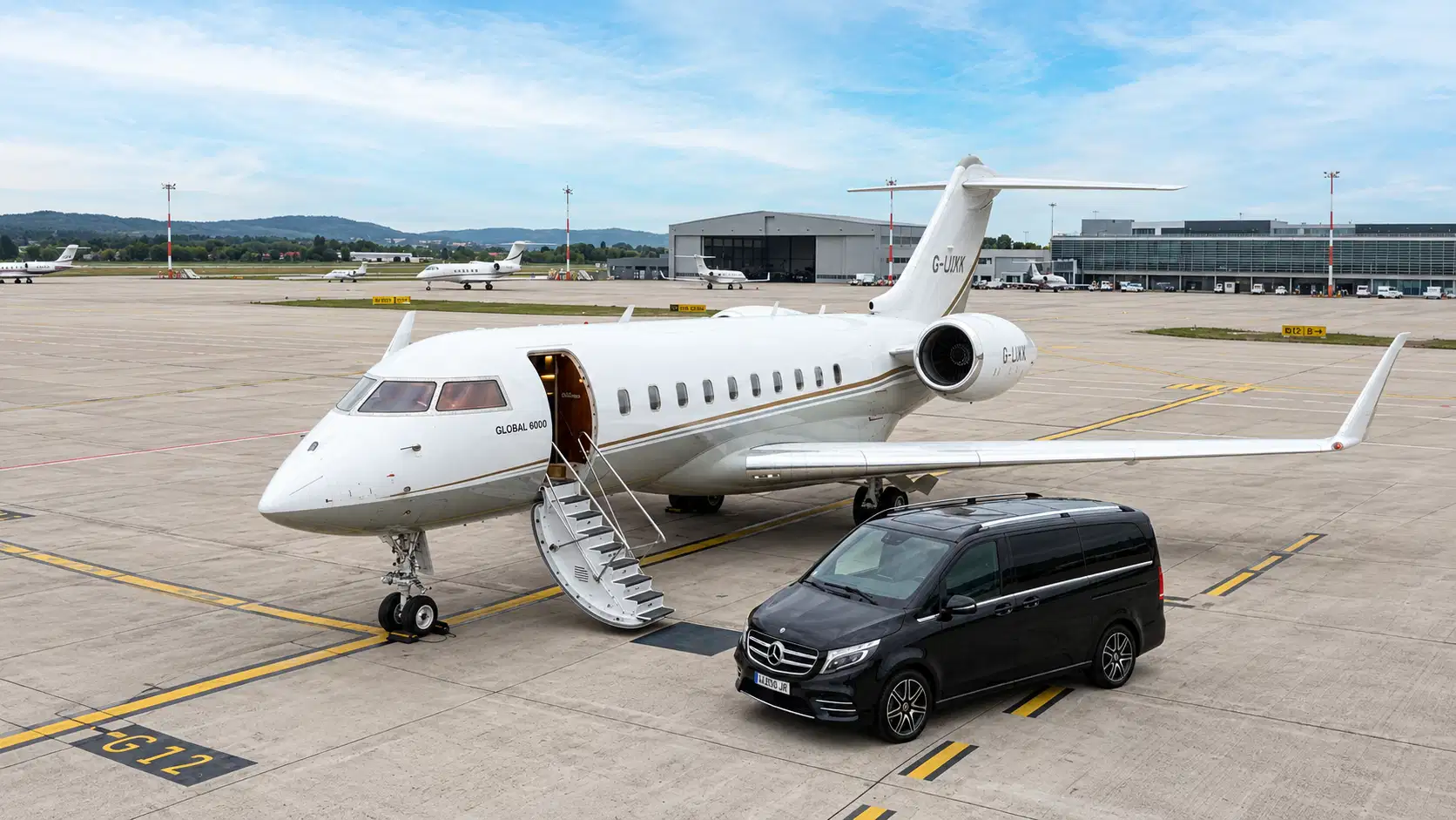 Mercedes V-Class waiting beside a private jet on the apron at Le Bourget