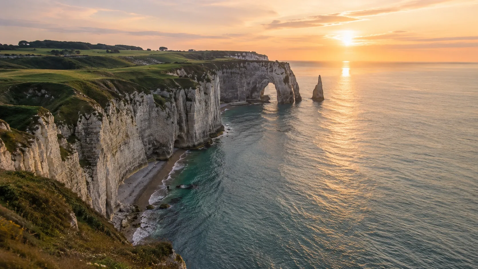 The white cliffs and sea arch of Étretat on the Normandy coast at sunset