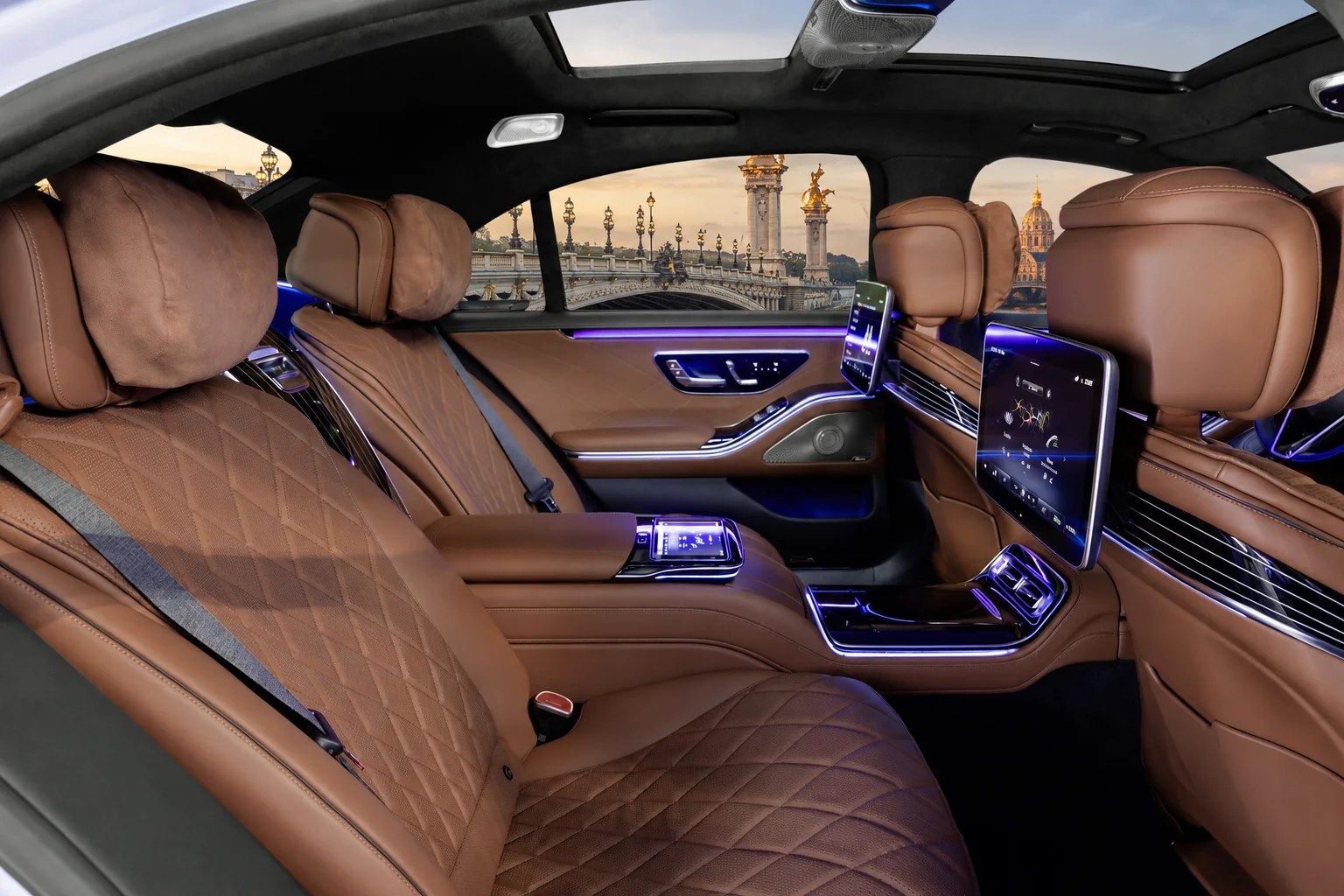 The rear cabin of a Mercedes-Benz S-Class, with the Pont Alexandre III visible through the window